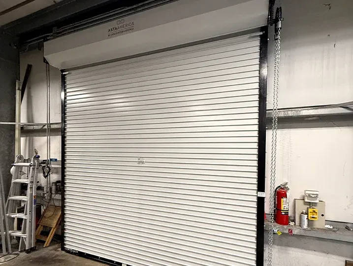 Heavy-duty Commercial Roll-Up Doors being serviced by a professional technician.